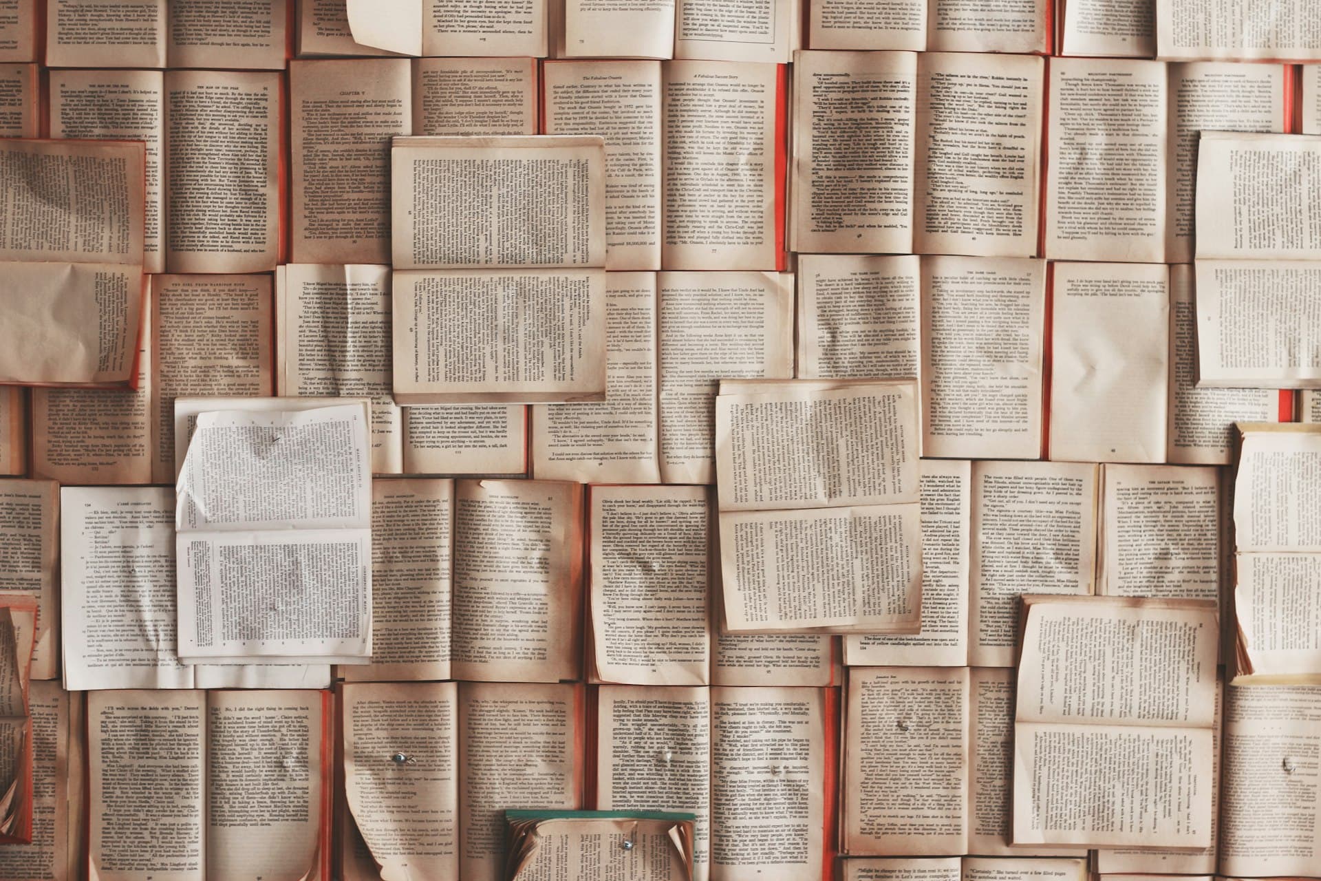 Dozens of open books pinned side by side