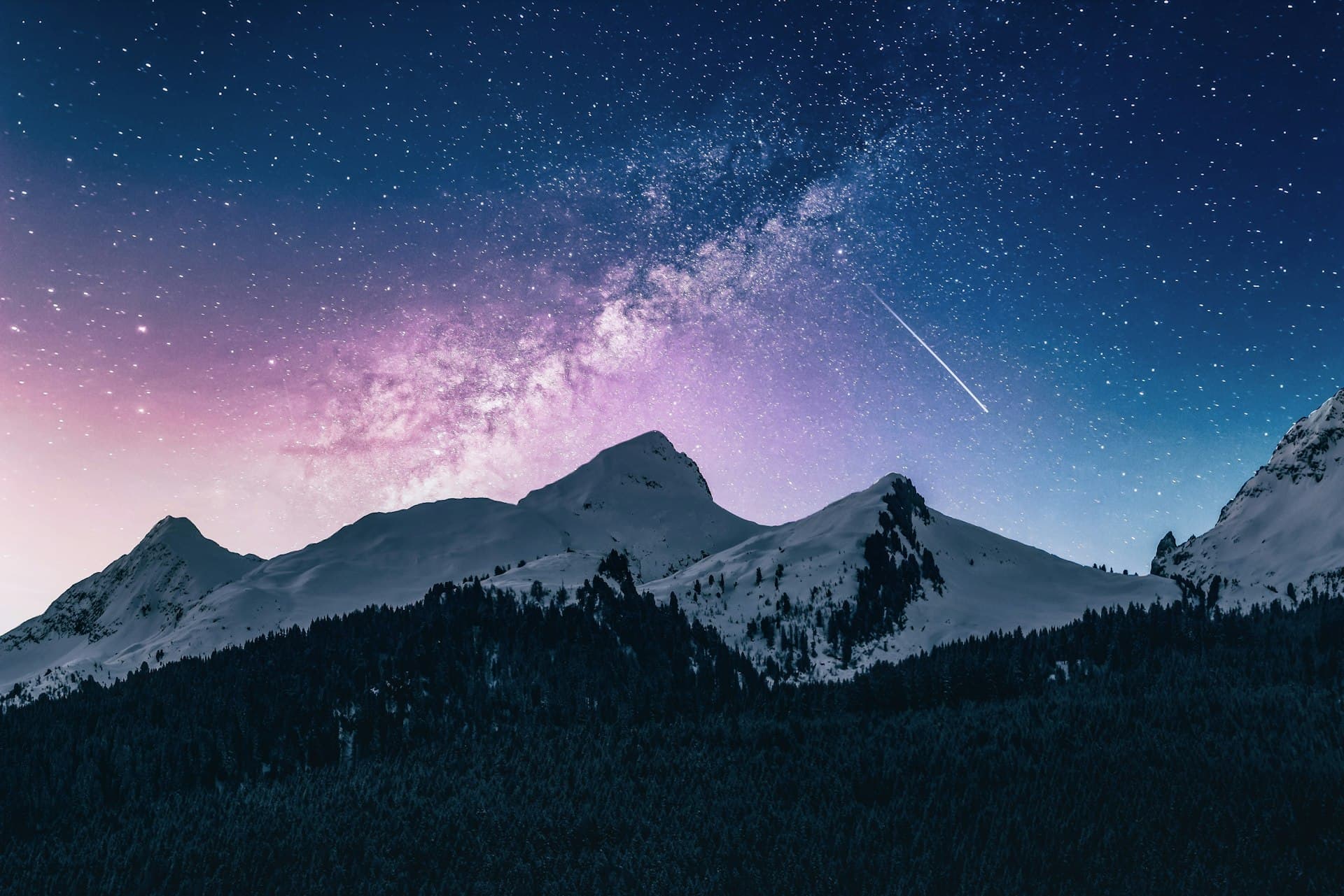 The Milky Way over snow-covered mountains